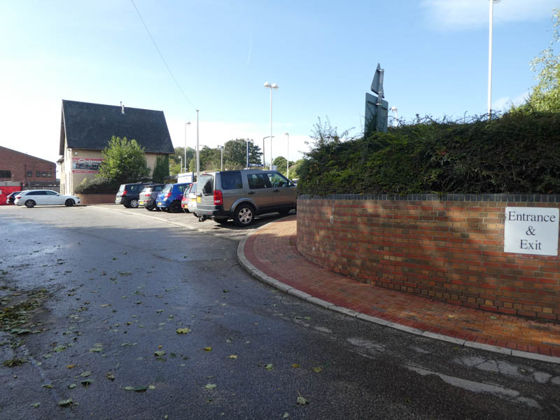 The entrance to the station car park, from the road just south of the level crossing