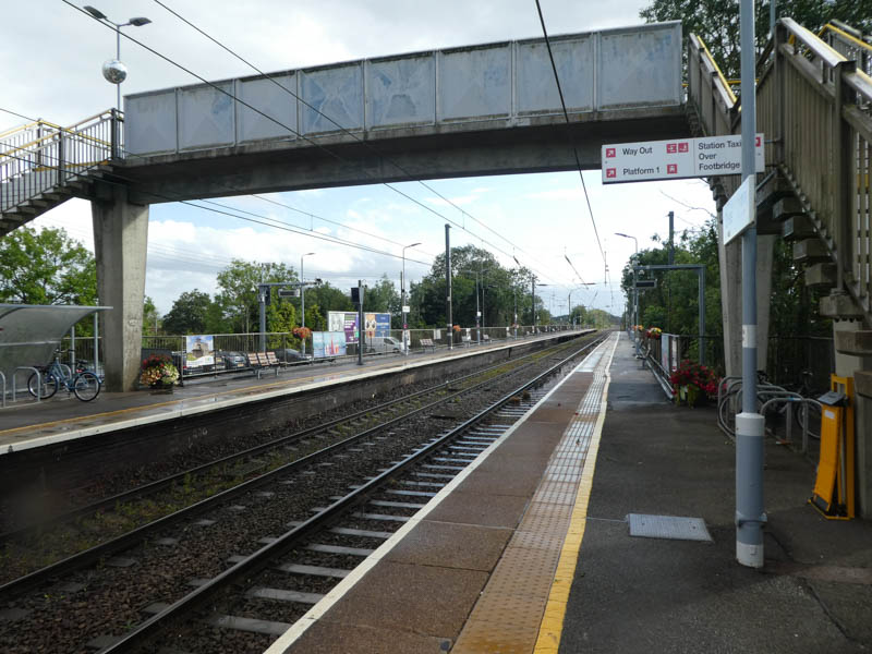At the foot of the footbridge on platform 2 looking south