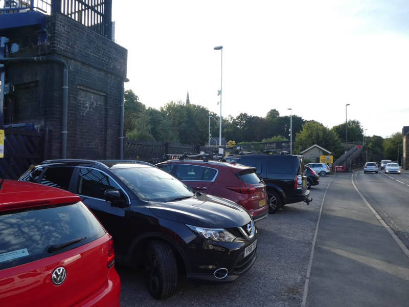 In the car park at Dronfield, with the footbridge on the left and the ramp ahead which provides level access to platform 2 opposite